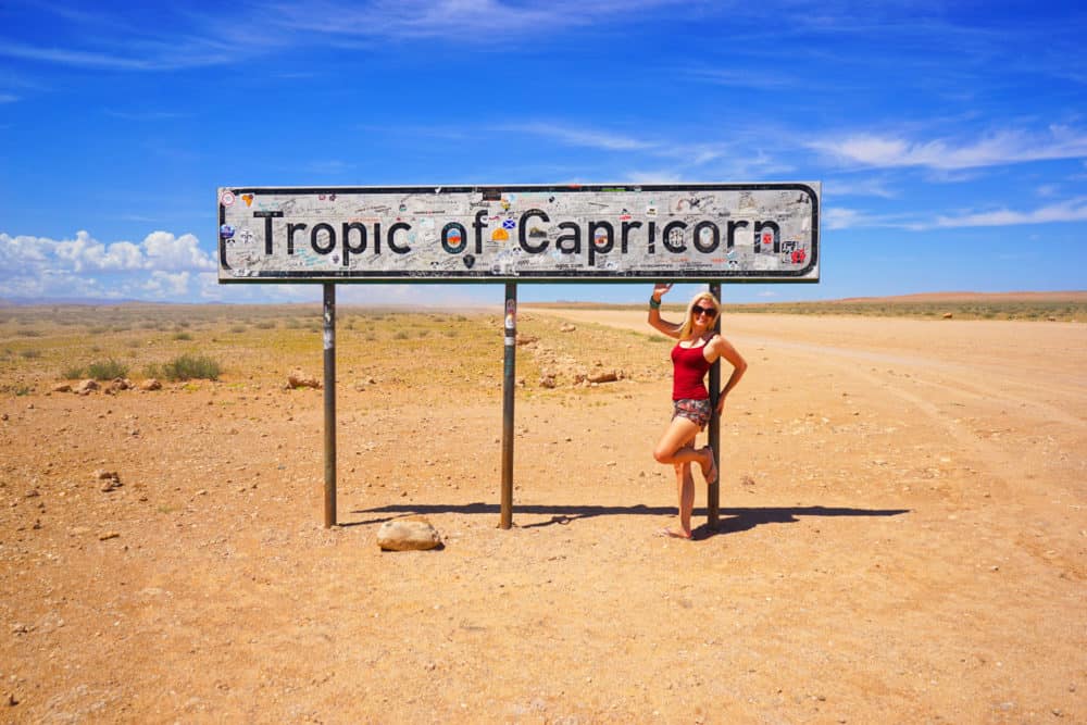 Lauren standing under a sign reading Tropic of Capricorn