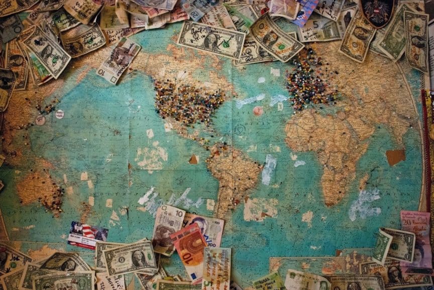 Map with pins and banknotes
