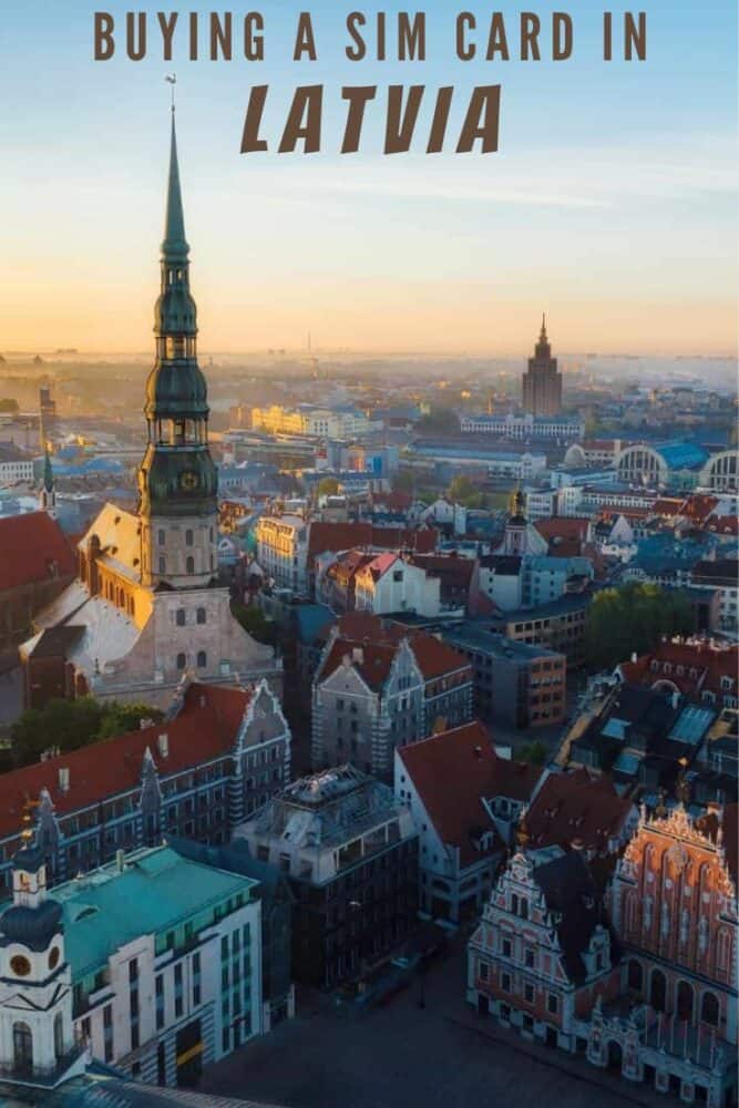 Aerial view of downtown Riga, in Latvia, at sunrise. Foreground is dominated by a large church spire. River visible in the distance. Text "Buying a SIM Card in Latvia" overlaid at top.