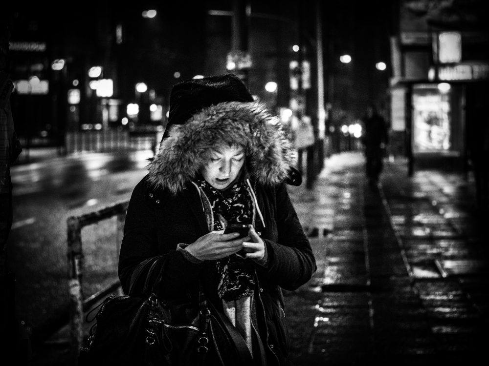 Woman with phone at night
