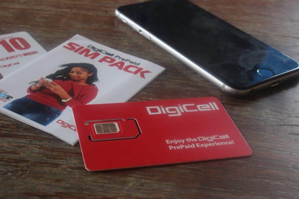 DigiCell SIM card packet and physical card sitting beside a phone on a table.