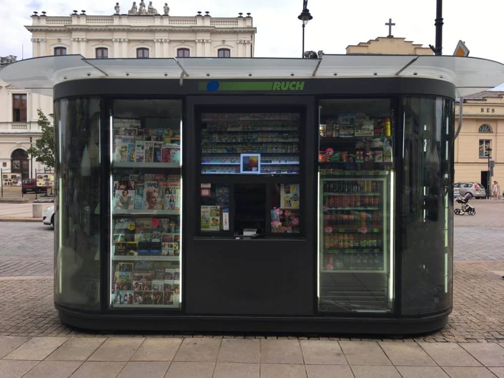 Kiosk selling magazines, drinks, and other items on the side of a street in Warsaw, Poland