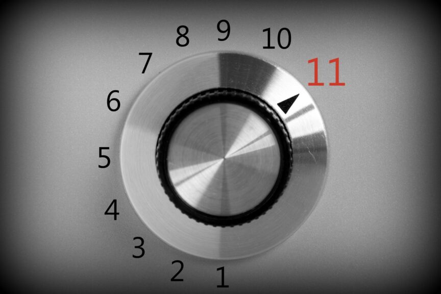 Black and white closeup image of a volume dial with a 1 to 11 scale that is turned to 11
