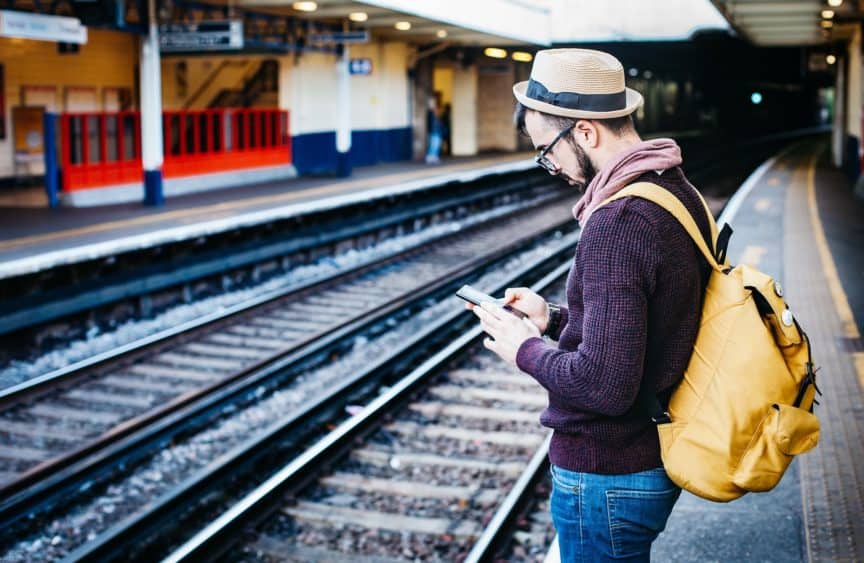Man on phone waiting for train