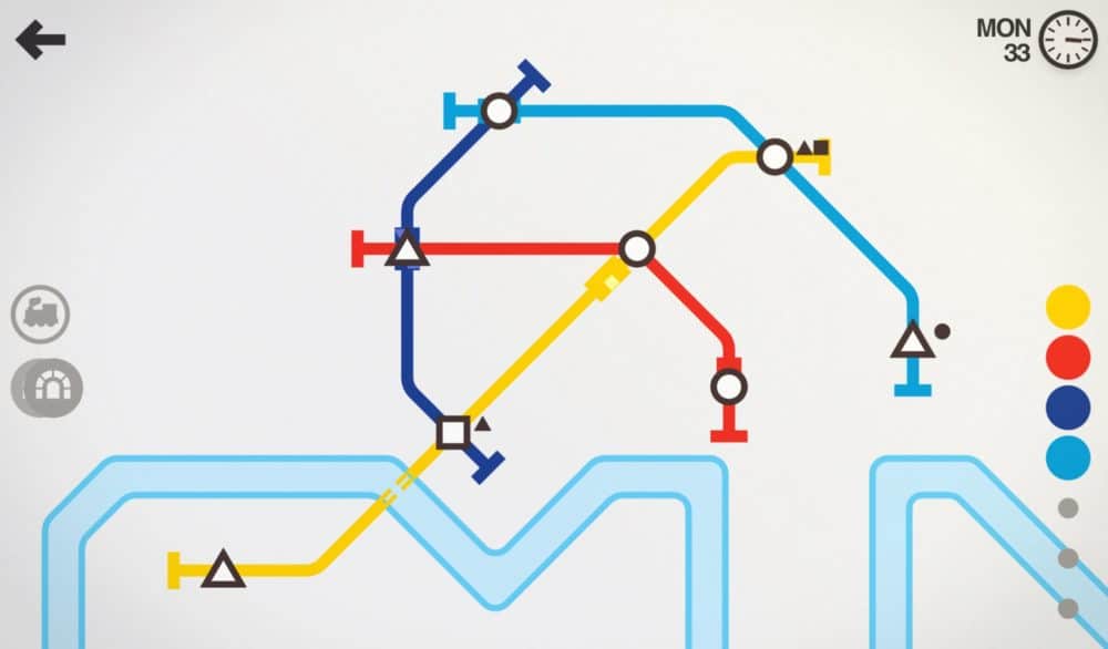 Screenshot from Mini Metro game, with different-colored lines connecting several circles, triangles, and squares. Stylized river at bottom of screen.
