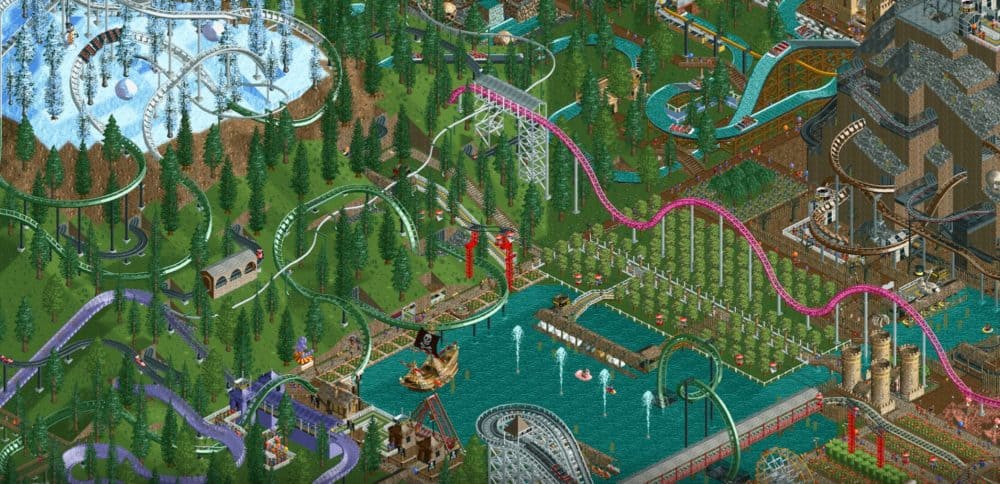 Screenshot from Roller Coaster Tycoon Classic game, with several complicated roller coasters and other themepark rides in a forest setting.