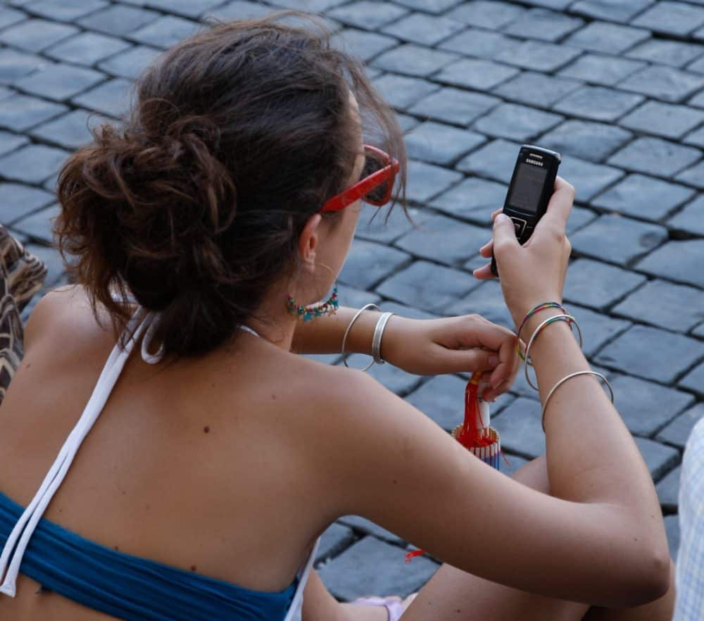 Woman sitting down using phone