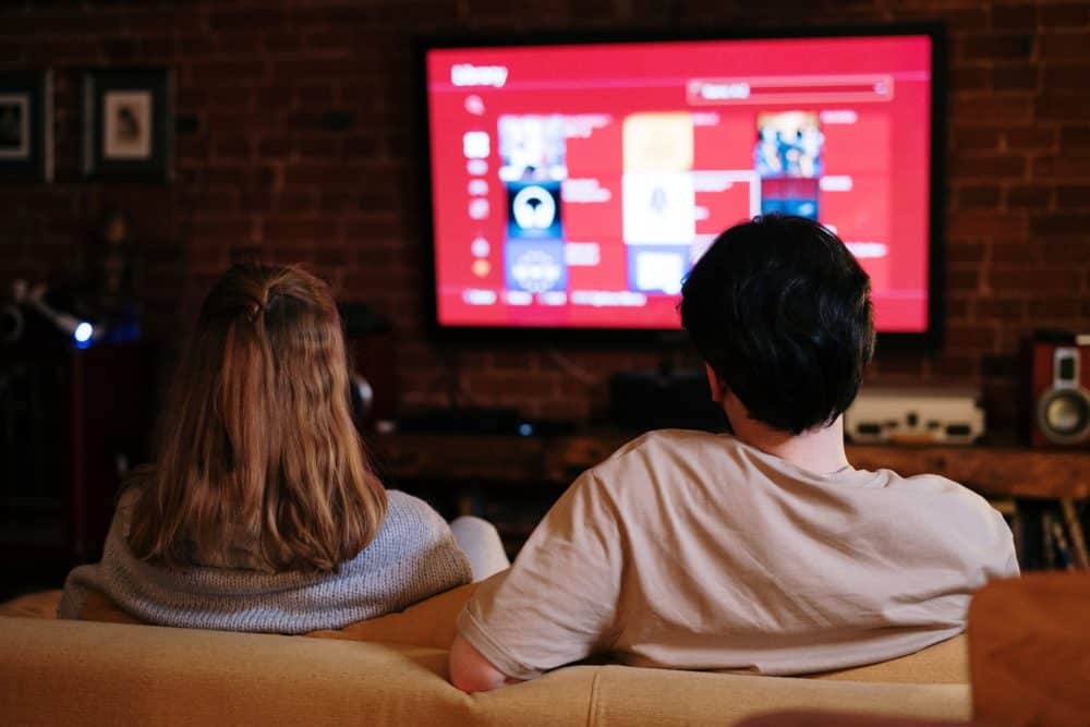 Couple watching Netflix on sofa