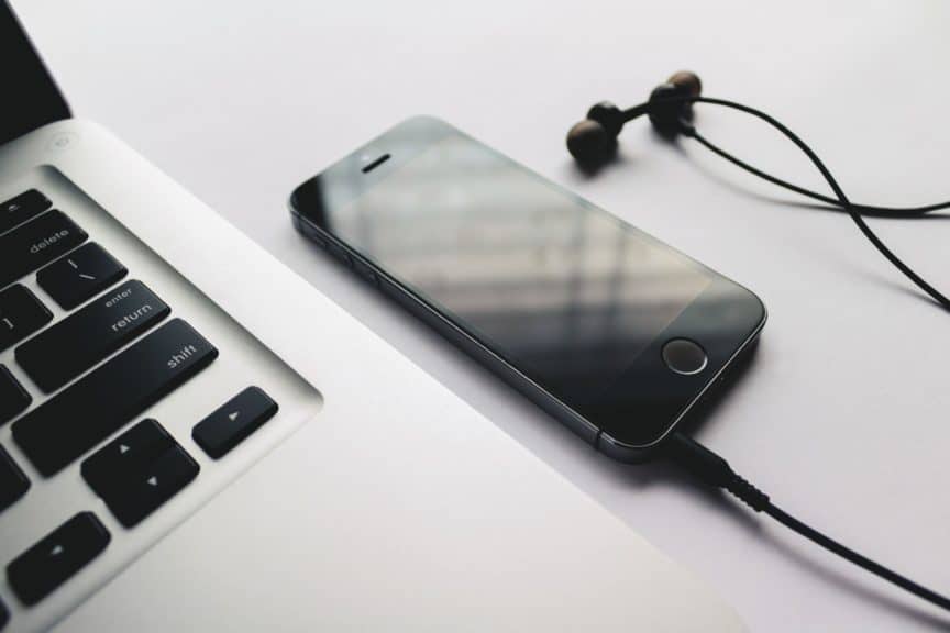 Laptop, phone, and earbuds
