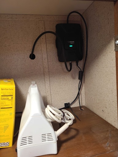 WeBoost signal booster inside cupboard