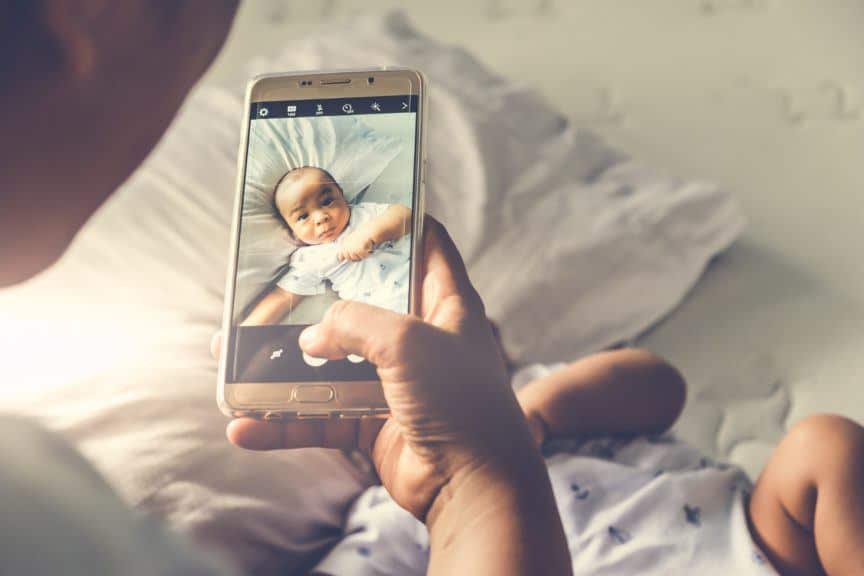 Woman taking photo of baby