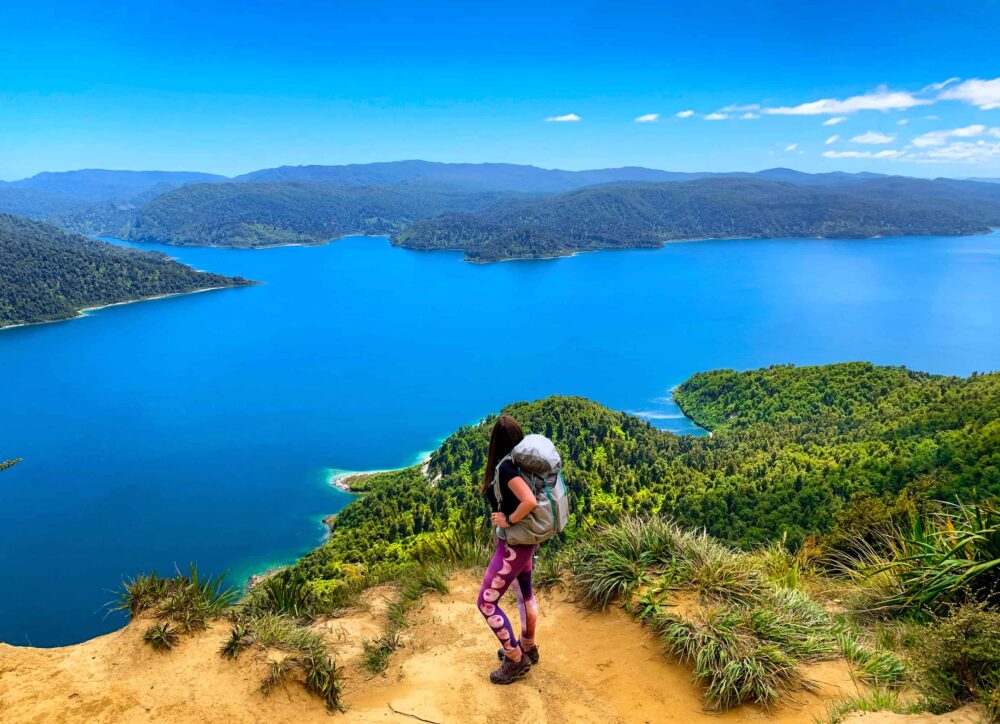 Lauren looking over a lake during a hike