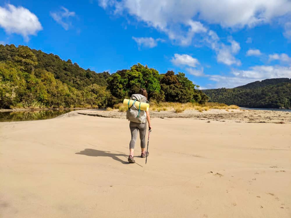 Lauren hiking on a beach