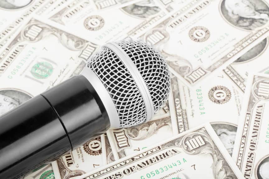 Microphone sitting on a bed of money