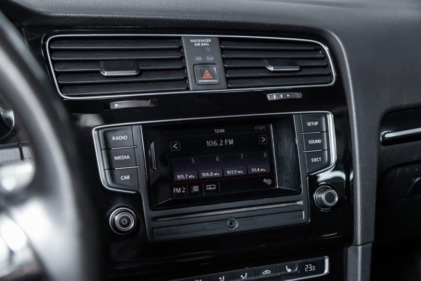 Closeup of car stereo showing FM frequency on screen