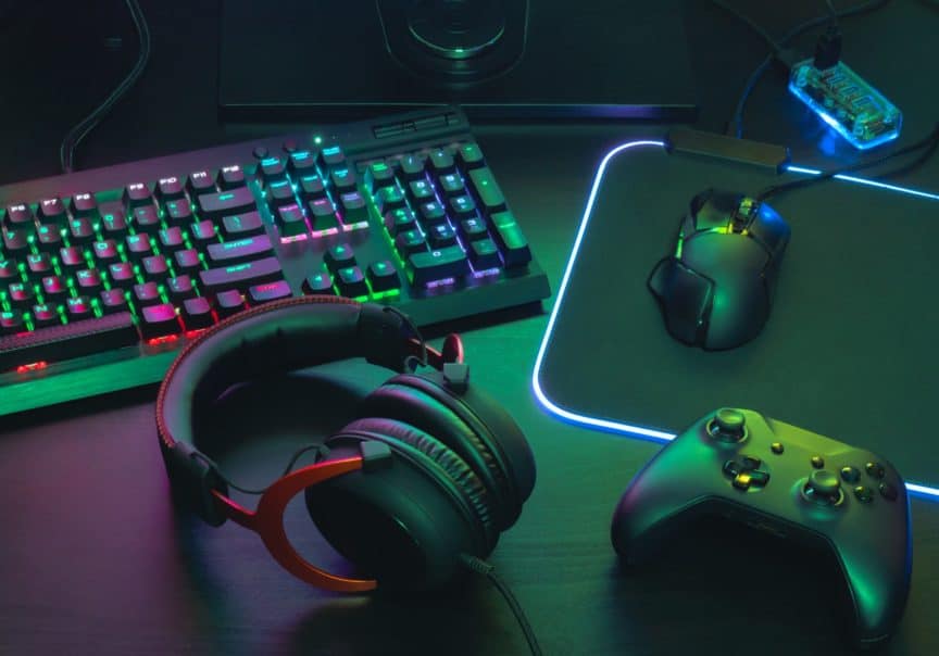 Gaming accessories, including keyboard, mouse, headphones, and mousepad
