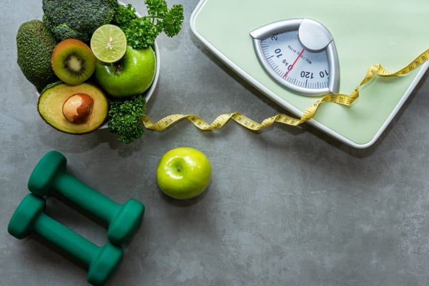 Scales, healthy food, weights, and a tape measure
