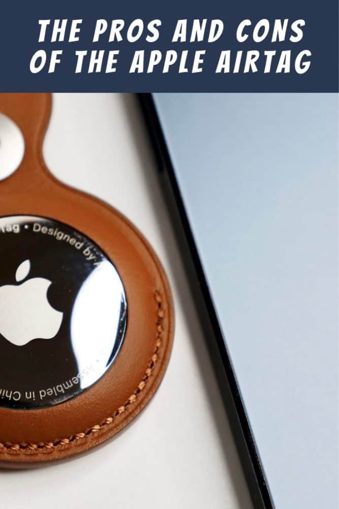 Apple Airtag in a keychain holder beside an Apple iPhone, with text "The Pros and Cons of the Apple Airtag" at top
