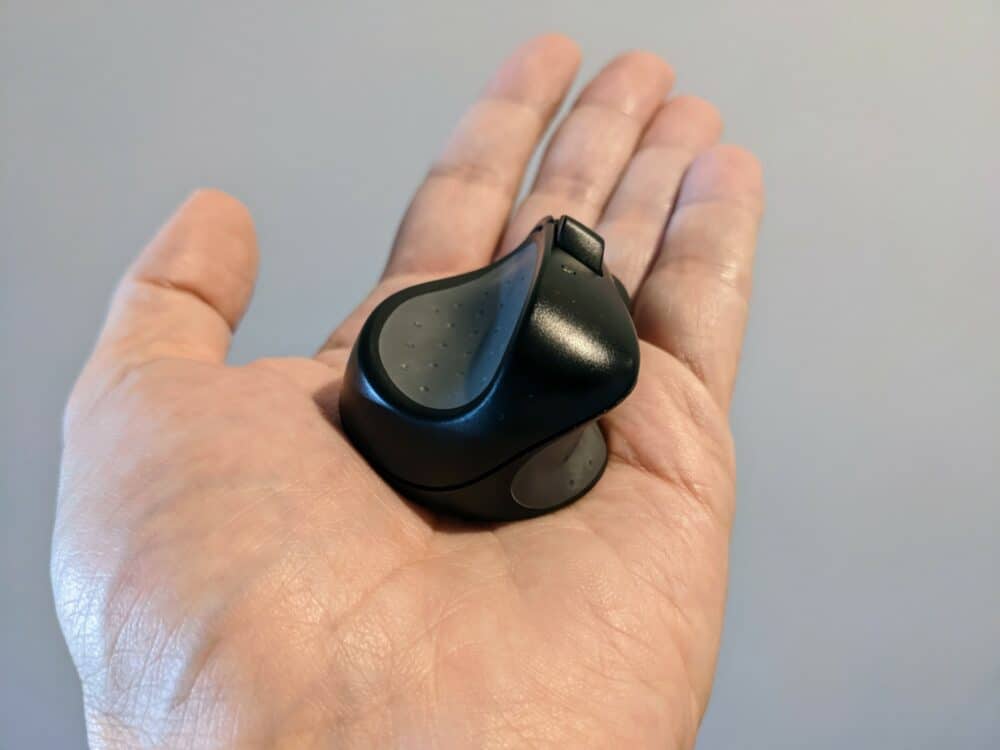Rear view of Swiftpoint ProPoint mouse sitting in the palm of an adult hand