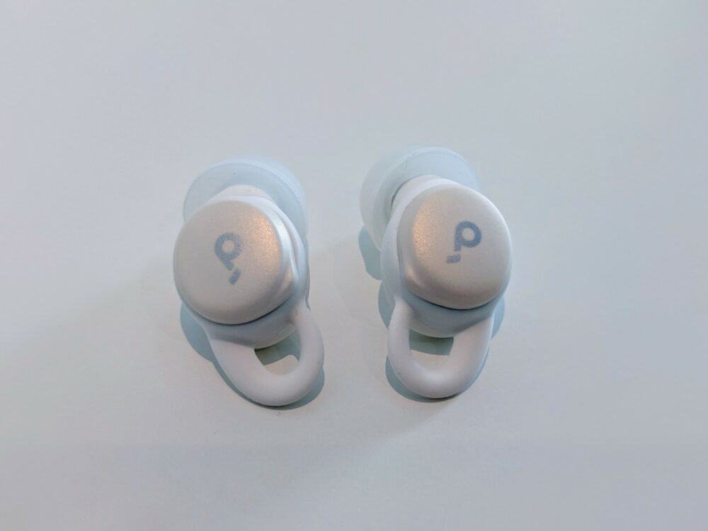 Pair of Soundcore Sleep A10 earbuds case sitting beside each other on a white table