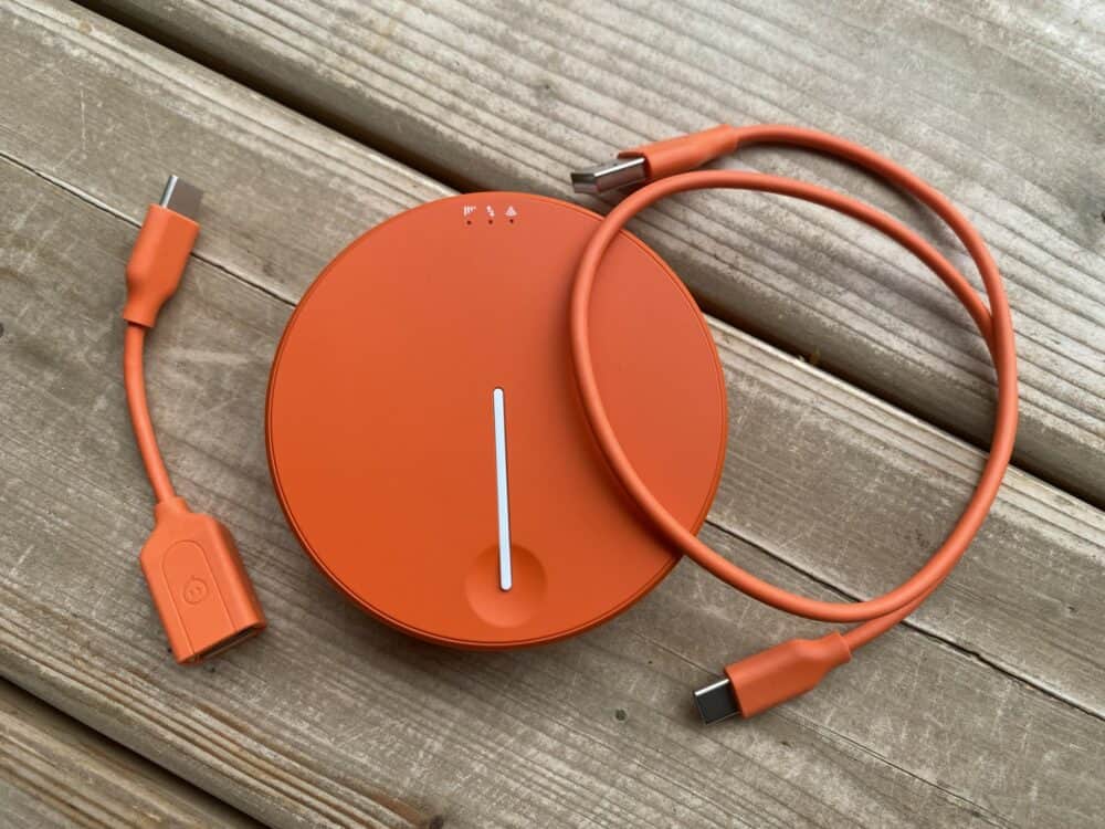 Solis Lite with charging cable and adapter on table