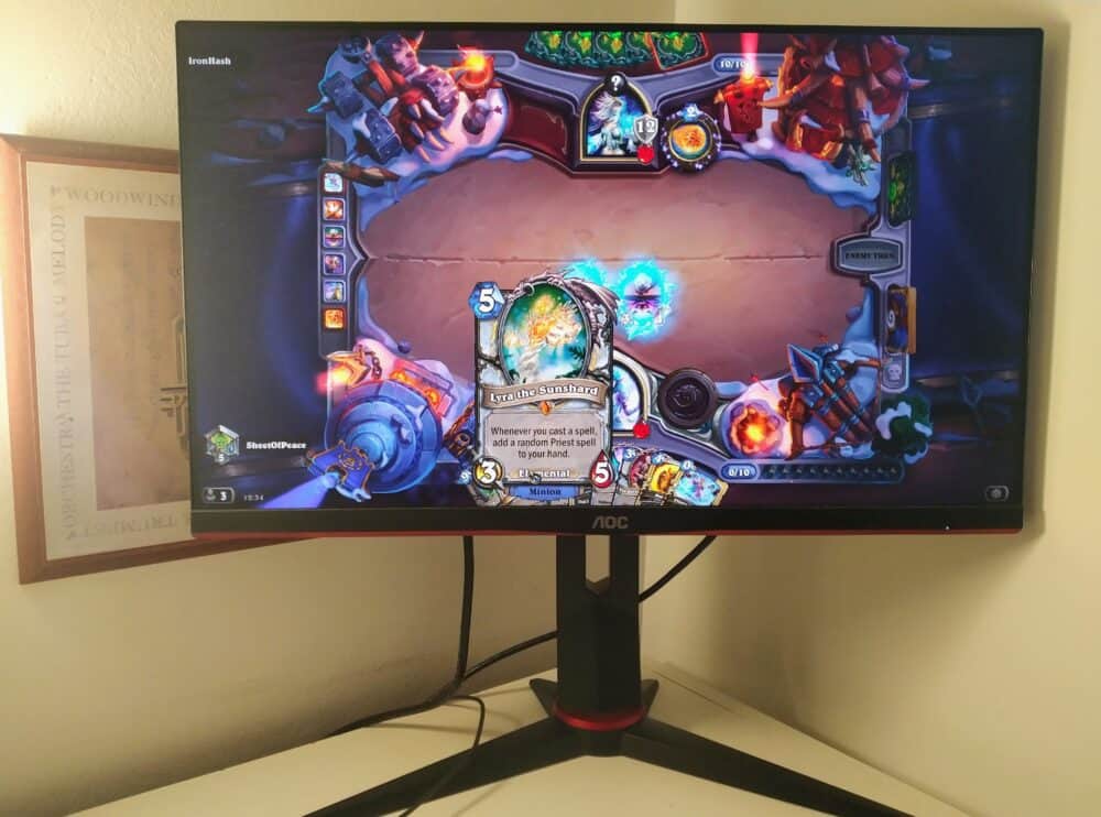 AOC 24G2 on desk showing in-game scene from Hearthstone game