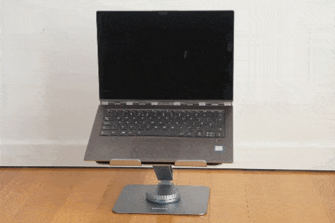 Animation of laptop rotating on uGreen 360 laptop stand, with wall in background and wooden floor