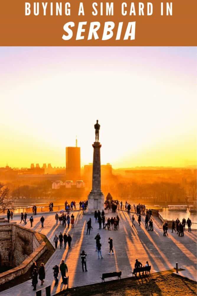 Statue and silhouettes of people at fortress Kalemegdan in Belgrade, Serbia at sunset, with text "Buying a SIM Card in Serbia" at top