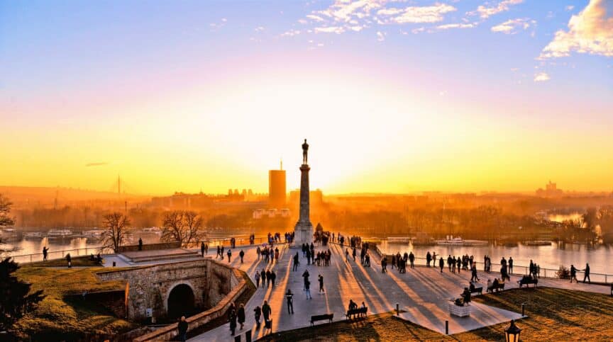 Statue and silhouettes of people at Fortress Kalemegdan in Belgrade, Serbia at sunset