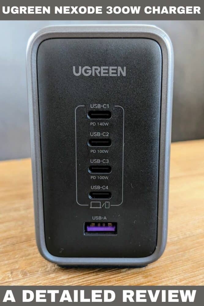 Close-up of Ugreen Nexode 300W desktop charger sitting on wooden table, with text "UGreen Nexode 300W Charger" at top and "A Detailed Review" at bottom