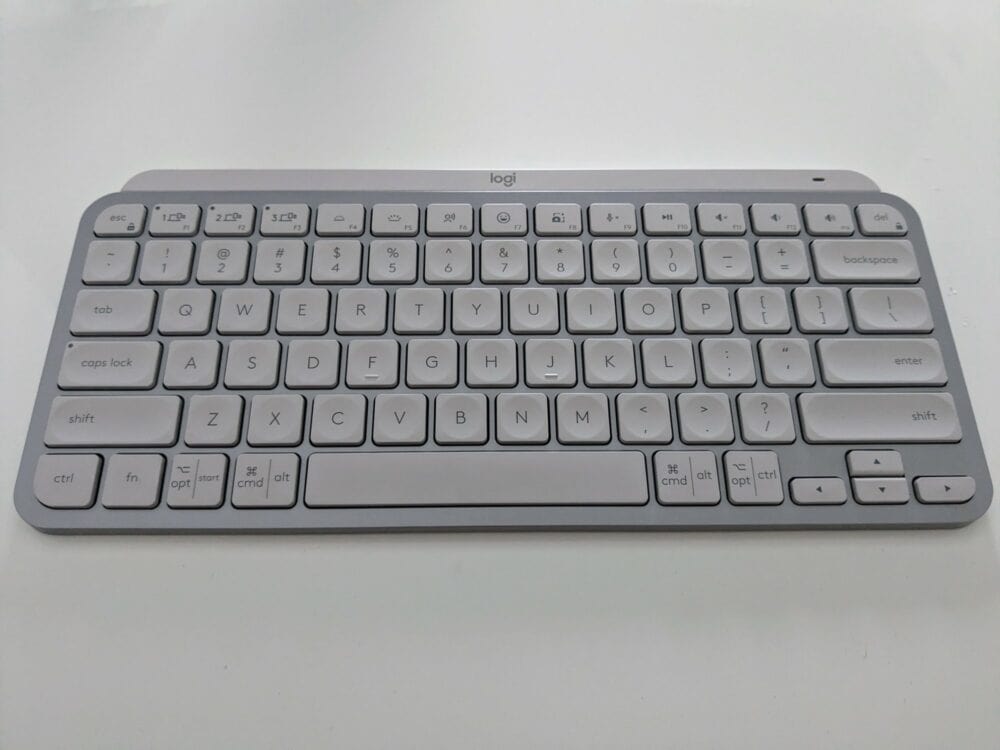 Pale grey keyboard on white desk, with "logi' logo at the top.