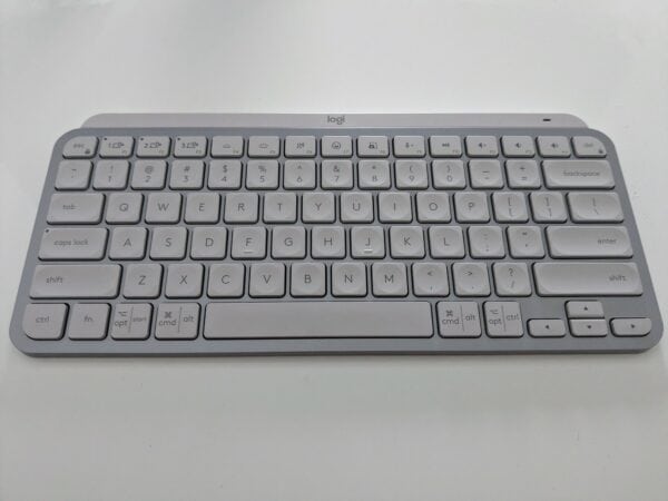 Pale grey keyboard on white desk, with "logi' logo at the top.