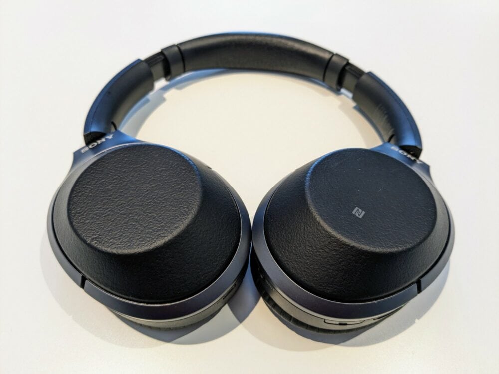 Closeup of Sony headphones on a white desk.