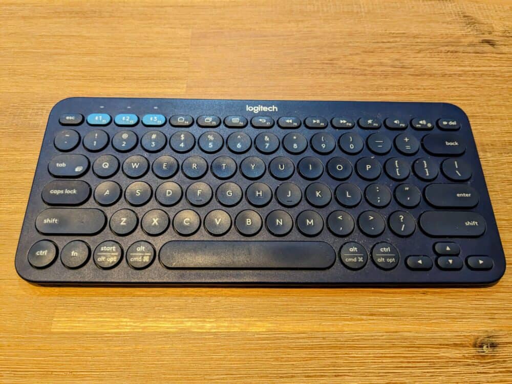 Small blue keyboard on wooden table