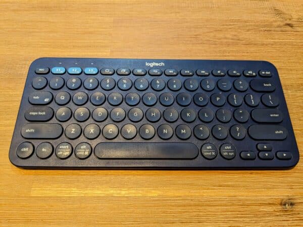 Closeup of a small blue keyboard on wooden table