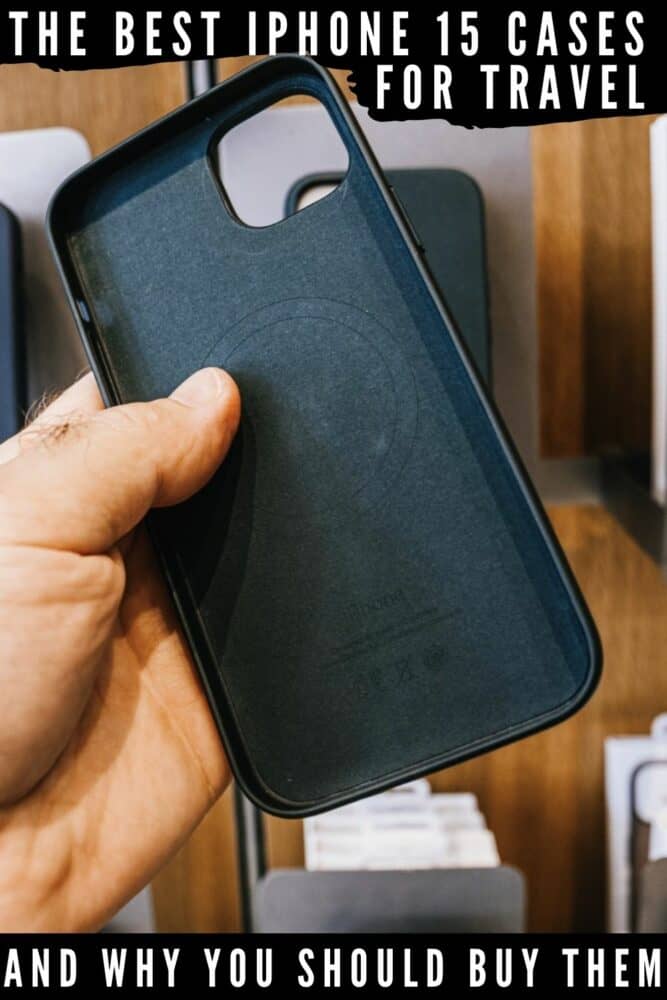 Male hand holding iPhone 15 case in front of wall of similar display cases, with text "The best iPhone 15 cases for travel" overlaid at top and "and why you should buy them" at bottom