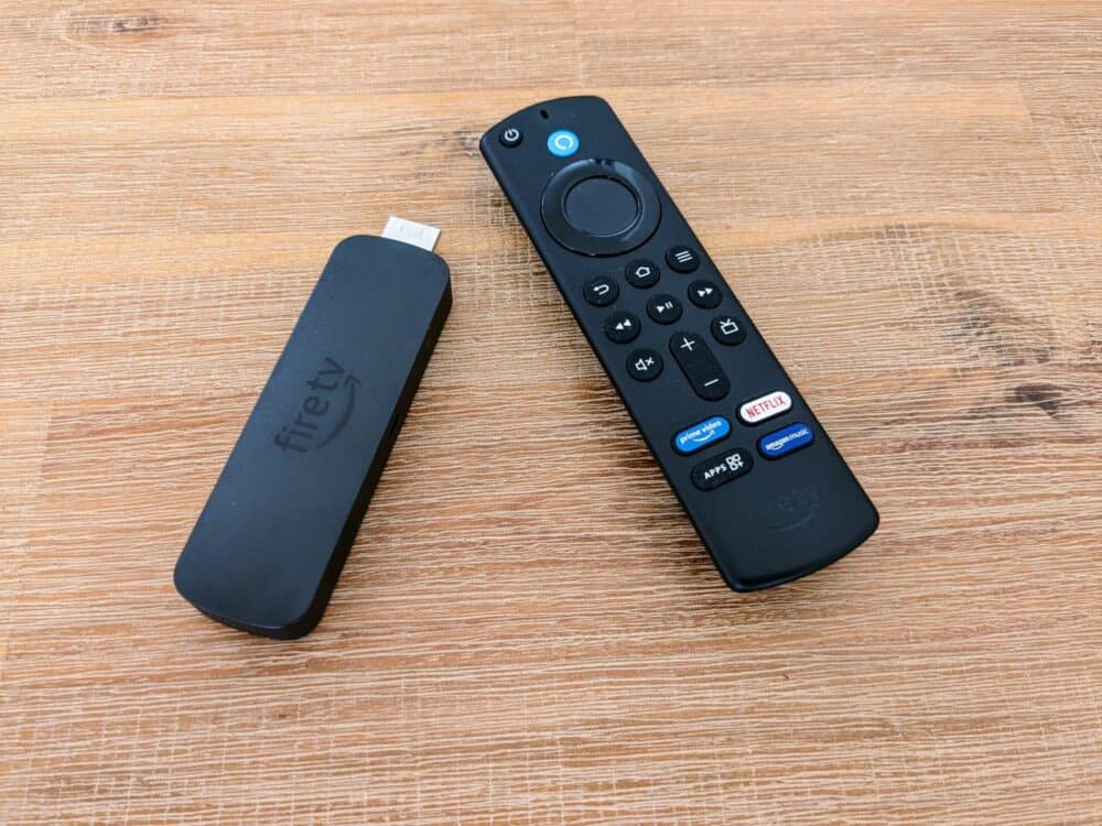 Amazon Fire TV stick and remote control lying beside each other on a wooden table