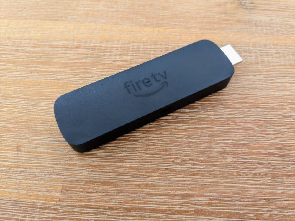 Amazon Fire TV Stick lying flat on a wooden table