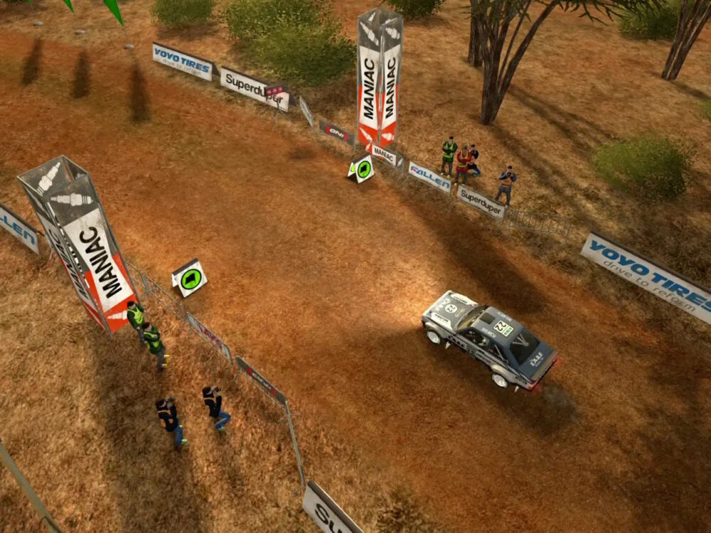 Screenshot of Rush Rally Origins game, showing a rally car approaching the finish line on a dirt track.