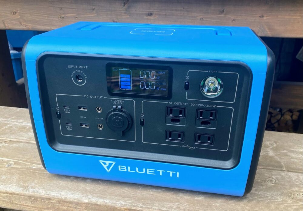 Large blue power bank sitting on a wooden bench